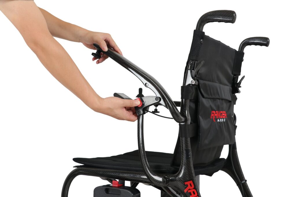Porto Mobility Ranger Aero folding power wheelchair, hands lifting the armrest while pressing its red release button