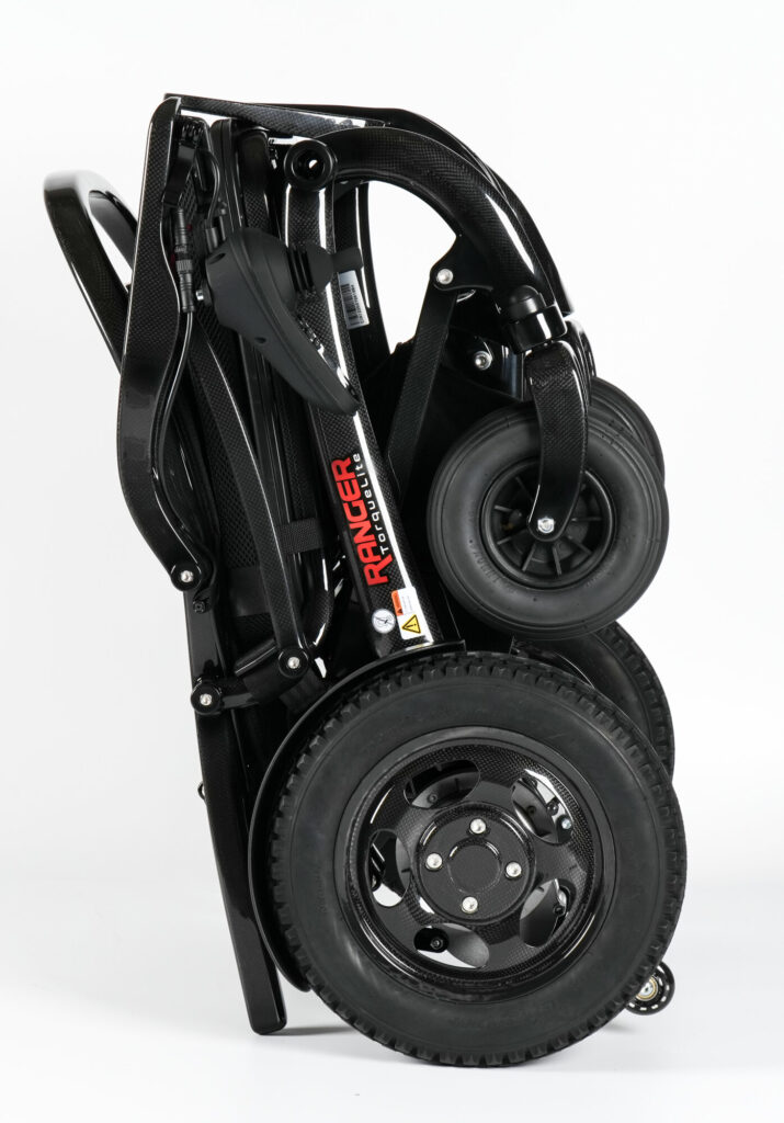 Porto Mobility Ranger TorqueLite folding power wheelchair folded and standing upright